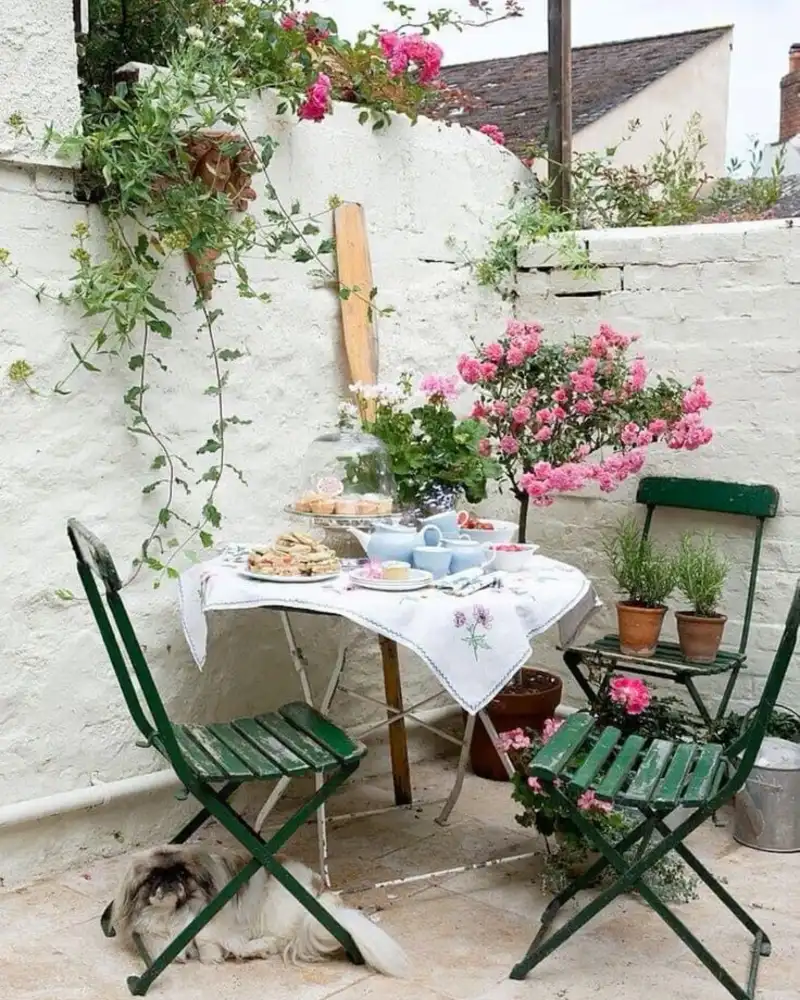 Vintage Tea Table Beside A Blooming Wall