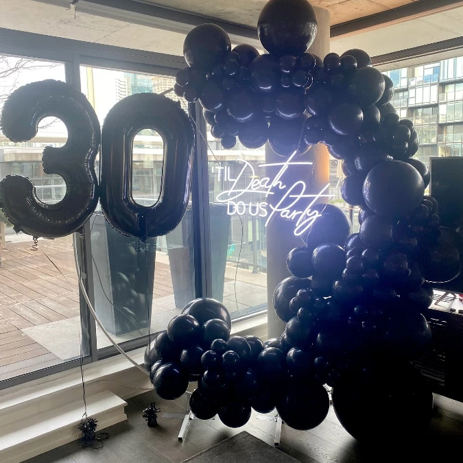 Neon Halo and Black Balloon Display