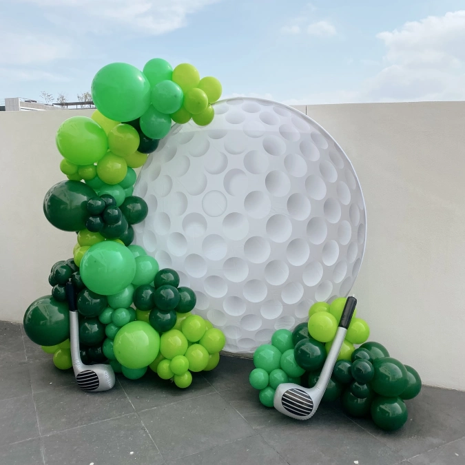 Giant Golf Ball Backdrop and Green Balloons